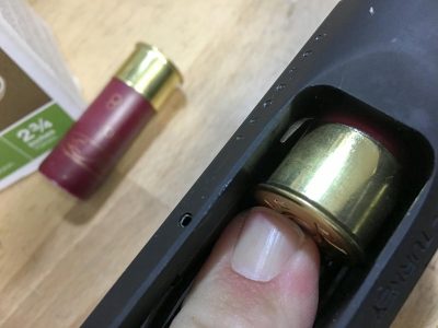 You'll need to press the locking tab to remove each shell from the magazine.