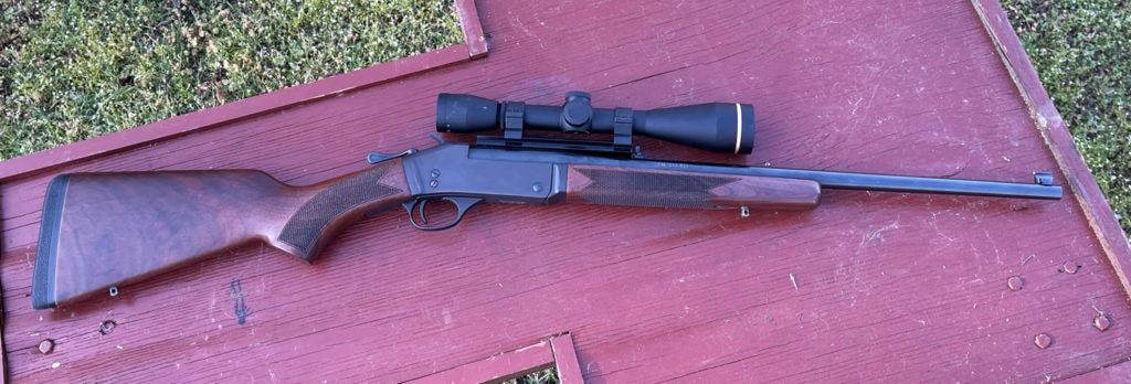 Henry Single Shot Rifle in .243 Winchester topped with a Leupold Scope.