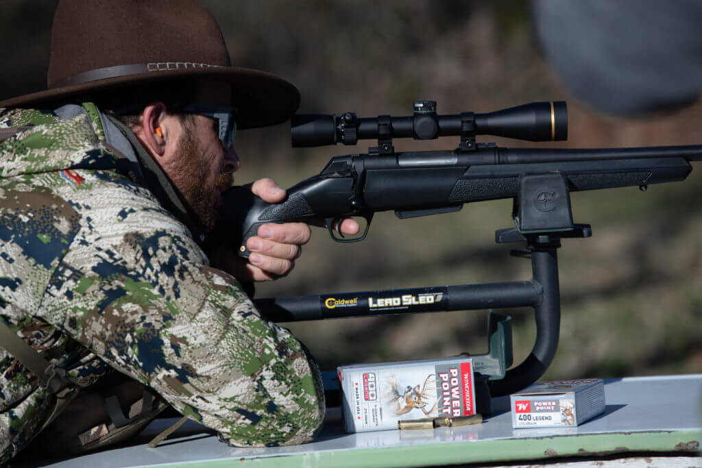 Hunter looking through bolt-action rifle, ready to use his 400 Legend 