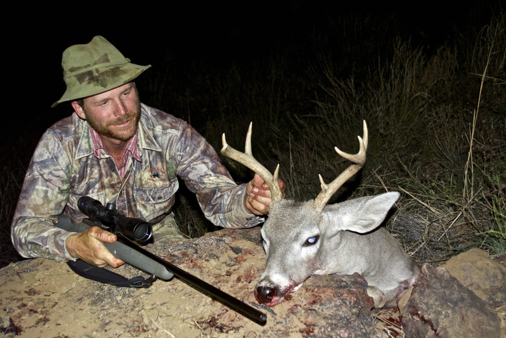 Hunter with his coues deer and his rifle